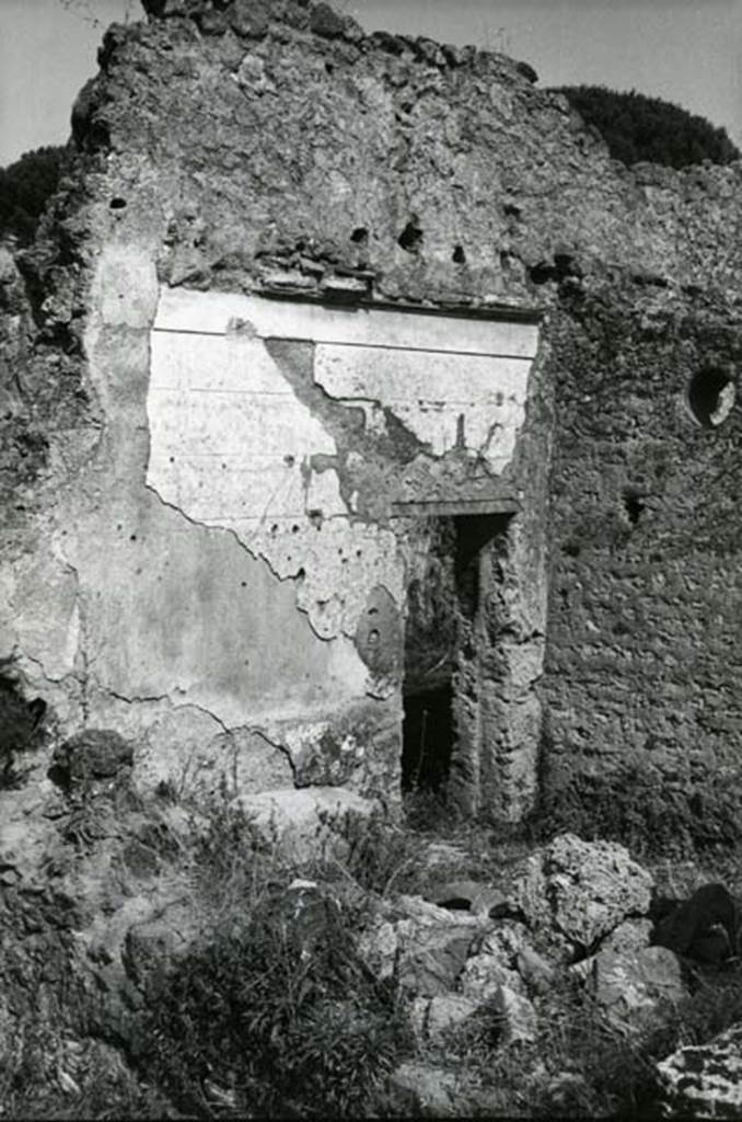 I.20.4 Pompeii. 1974. Shop House, room at NW corner of courtyard/atrium, looking towards entrance in E wall.  Photo courtesy of Anne Laidlaw.
American Academy in Rome, Photographic Archive. Laidlaw collection _P_74_3_9.
According to PPM, this room (in the north-west corner of the atrium/courtyard) which had been a cubiculum was then converted into the kitchen and latrine. In the north-west corner of this room was the latrine.  The floor was of cocciopesto, and embedded with pieces of white tesserae under the area of the bed, with a decorative scheme including meanders and a double diamond pattern outlined with white tesserae in the antechamber. The wall was decorated with relief stucco in the I style, with the zoccolo decorated with prospective cubes surmounted by a top of imitation alabaster and by bosses. The bench of the kitchen and supports for the latrine, leaning against the north wall, were already collapsed in 1977, together with the north wall. 


