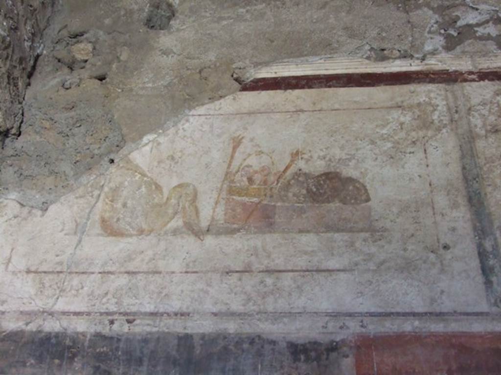 II.1.12 Pompeii. March 2009. Upper part of west wall of triclinium with wall painting of a swan, a basket and two torches. 