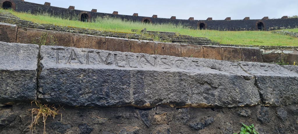 II.6 Pompeii. April 2022. Inscription carved on rim of inner wall of the arena of the amphitheatre -
Part inscription T. ATVLLIVS C. F.  
According to CIL X this is the start of the inscription
T. ATVLLIVS C. F. CELER II V. PRO LVD LV CVN F. C. EX. D. D.   [CIL X 854]
Photo courtesy of Giuseppe Ciaramella.
