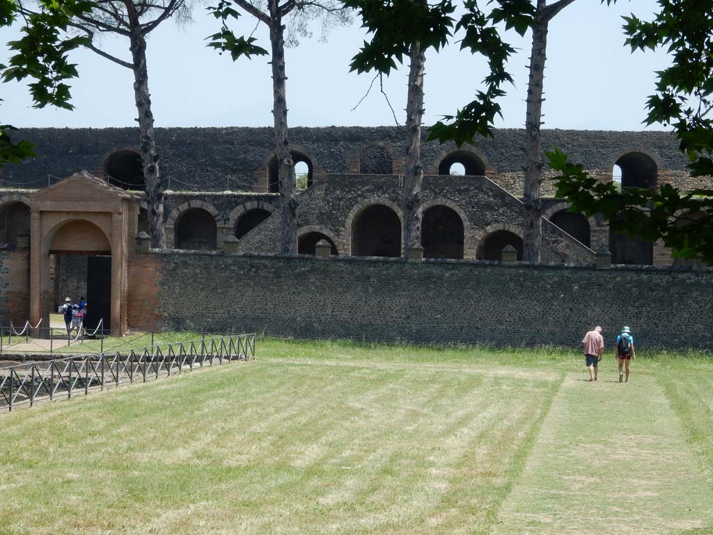 II.7 Pompeii. June 2019. Looking east along south side of pool, towards amphitheatre. Photo courtesy of Buzz Ferebee.
