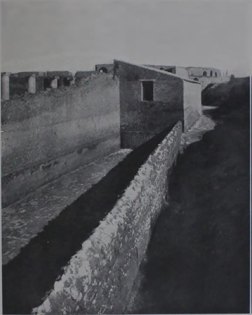 II.7.1/II.7.11 Pompeii. 1939.  “La forica della Palestra”. 
Looking east along south side of long tapered walled enclosure, towards the amphitheatre.
See Notizie degli Scavi, 1939, p. 191, fig.16.
