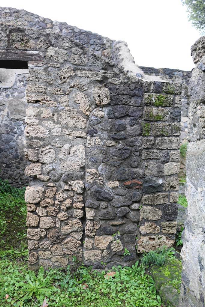 II.8.5 Pompeii. December 2018. 
Doorway to third room on north side of corridor, on left, and detail of north wall in corridor.  
Photo courtesy of Aude Durand.
