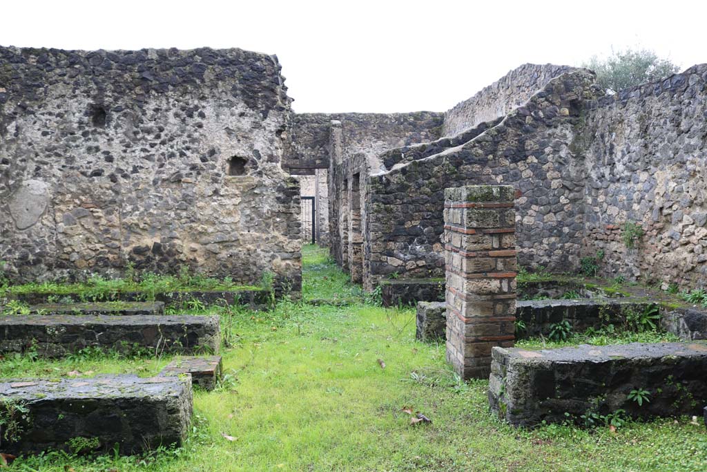 II.8.5 Pompeii. December 2018. 
Looking west towards atrium and entrance doorway, across three-sided stone benches and tables. Photo courtesy of Aude Durand.
