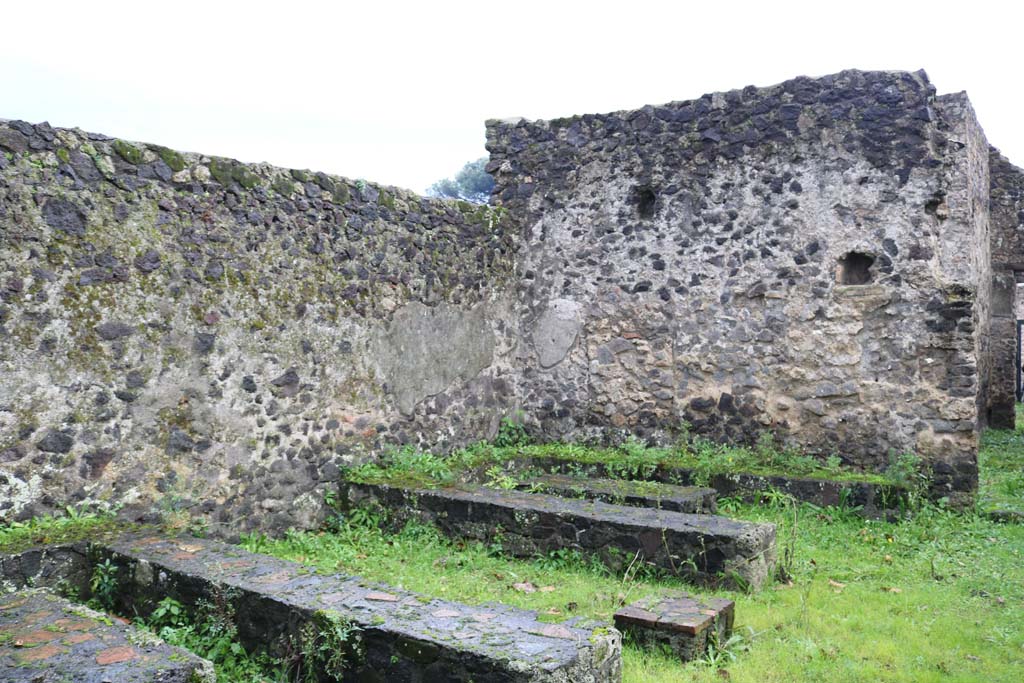 II.8.5 Pompeii. December 2018. 
Three-sided stone benches and tables built against the south wall, looking west. Photo courtesy of Aude Durand. 
