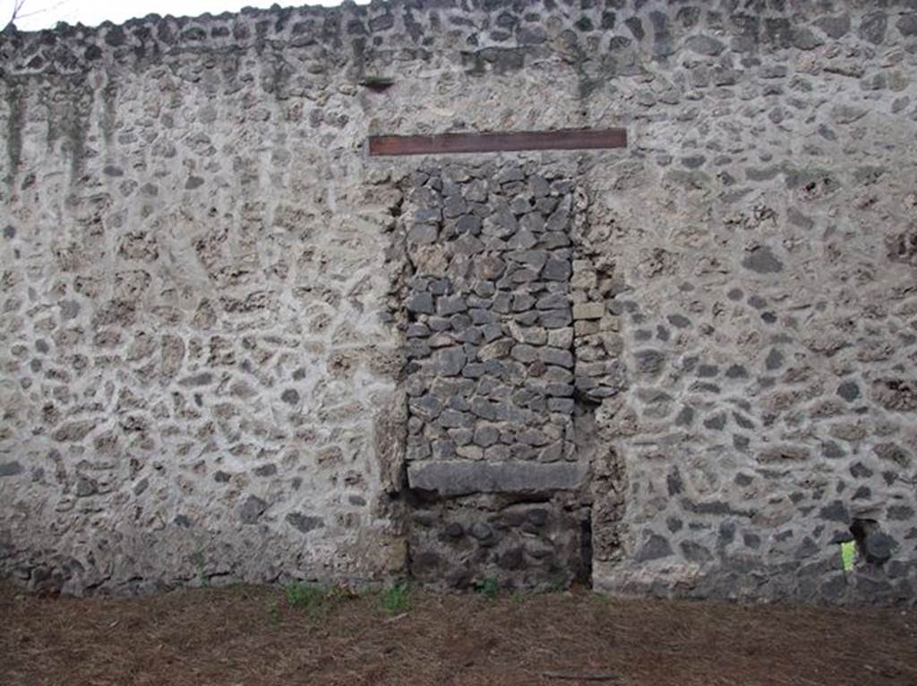 II.9.4 Pompeii. December 2006. Door blocked in antiquity in rear wall taken from vicolo on east side next to Palaestra.
