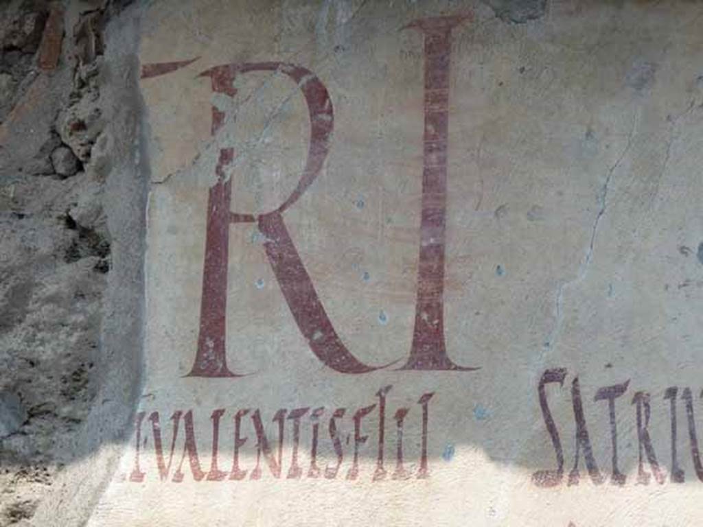 III.2.1 Pompeii. May 2010. Detail of graffiti outside House of Aulus Trebius Valens. [CIL IV 7992]
According to Epigraphik-Datenbank Clauss/Slaby (See www.manfredclauss.de) this read as
D(ecimi) Lucreti Satri Valentis flaminis [Neronis] Caesaris Aug(usti) f(ilii) perpetui glad(iatorum) par(ia) XX et D(ecimi) Lucreti Valentis fili(i) glad(iatorum) par(ia) X pugn(abunt) Pompeis ex a(nte) d(iem) V Nonis Apr(ilibus) venatio et vela erunt 
// Poly[bius(?)]       [CIL IV 7992]

According to Cooley, this is an advertisement for the gladiatorial games and can be translated as –
20 pairs of gladiators of Decimus (Polybius – signed by writer’s name, enclosed within the initial D of Decimus) Lucretius Satrius Valens, perpetual priest of ((Nero)) Caesar, son of Augustus, and 10 pairs of gladiators of Decimus Lucretius Valens will fight at Pompeii on 4? April. There will be a hunt and awnings.
She says that this was painted in Black and Red in around AD 50-68, and the name of Nero was plastered over, perhaps after he committed suicide in AD 68.
See Cooley, A. and M.G.L., 2004. Pompeii : A Sourcebook. London : Routledge. (p.v50).
