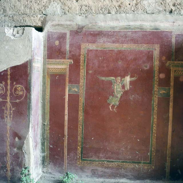 IIII.3.6 Pompeii. 1969. 
Detail of painting of winged figure and architectural design on plaster on east wall.
Photo courtesy of Alix Barbet (cl. A. Barbet POMP.00358, année 1969).

