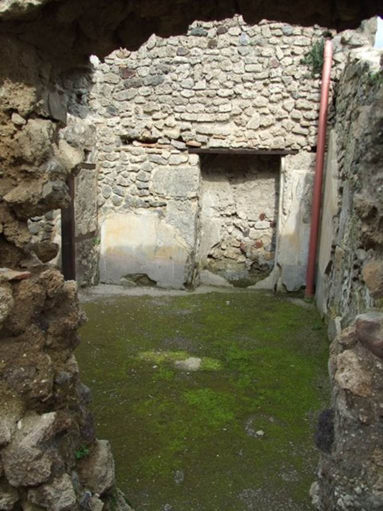 III.4.3  Pompeii.  March 2009.   Room 23.  Looking east through hole in the wall from room 22.