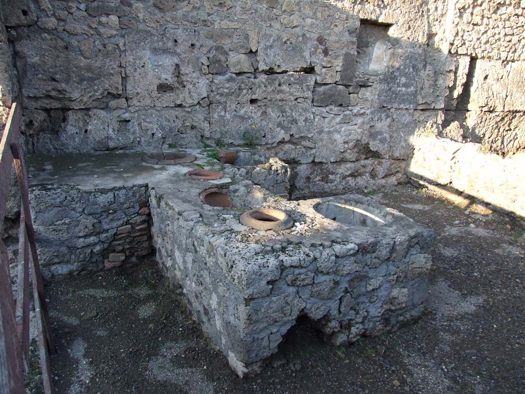 V.I.13 Pompeii. December 2006. Looking east across counter with remains of 6 urns.