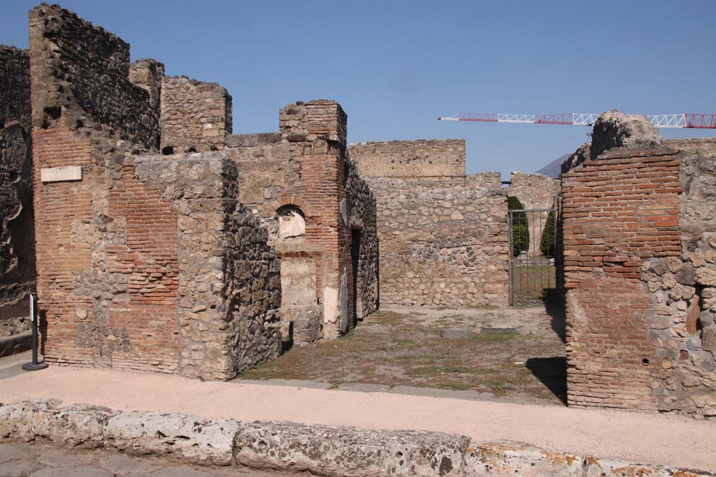V.2.1 Pompeii. September 2021.  
Looking towards entrance doorway in south-west corner of insula on Via di Nola, with the junction of Vicolo di Cecilio Giocondo, on left. 
Photo courtesy of Klaus Heese.
