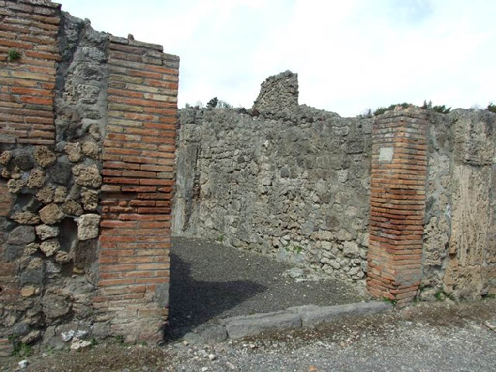 V.2.2 Pompeii. March 2009. Entrance doorway, with downpipe on left side of doorway.

