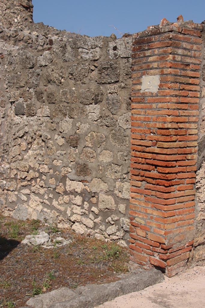 V.2.2 Pompeii. October 2023. 
East side of entrance doorway, and doorway threshold. Photo courtesy of Klaus Heese.

