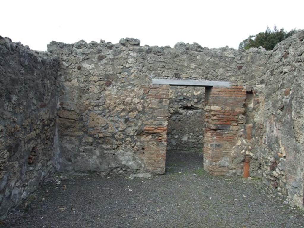 V.2.8 Pompeii. March 2009.  North wall of shop, with doorway to rear room.