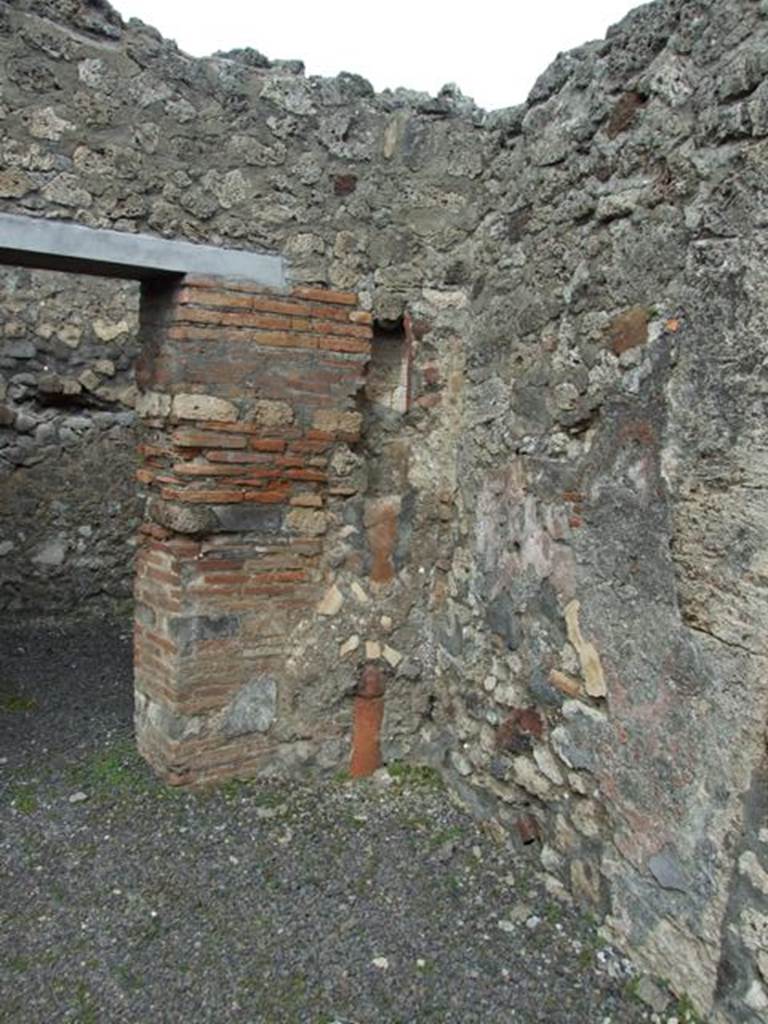 V.2.8 Pompeii. March 2009.  On the rear east wall were the stairs to upper floor, and underneath was the Latrine. In the north east corner is a downpipe from upstairs.