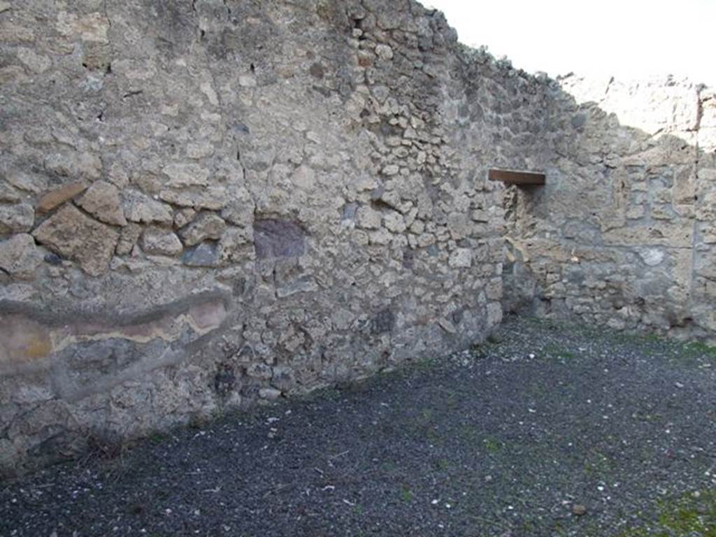 V.2.10 Pompeii. December 2007. West side of atrium with doorway to room 2. According to NdS, when excavated not much of the wall decoration remained other than a small piece of yellow dado. In the west wall of the atrium was the doorway to the narrow room, room 2, a cupboard or storeroom.
