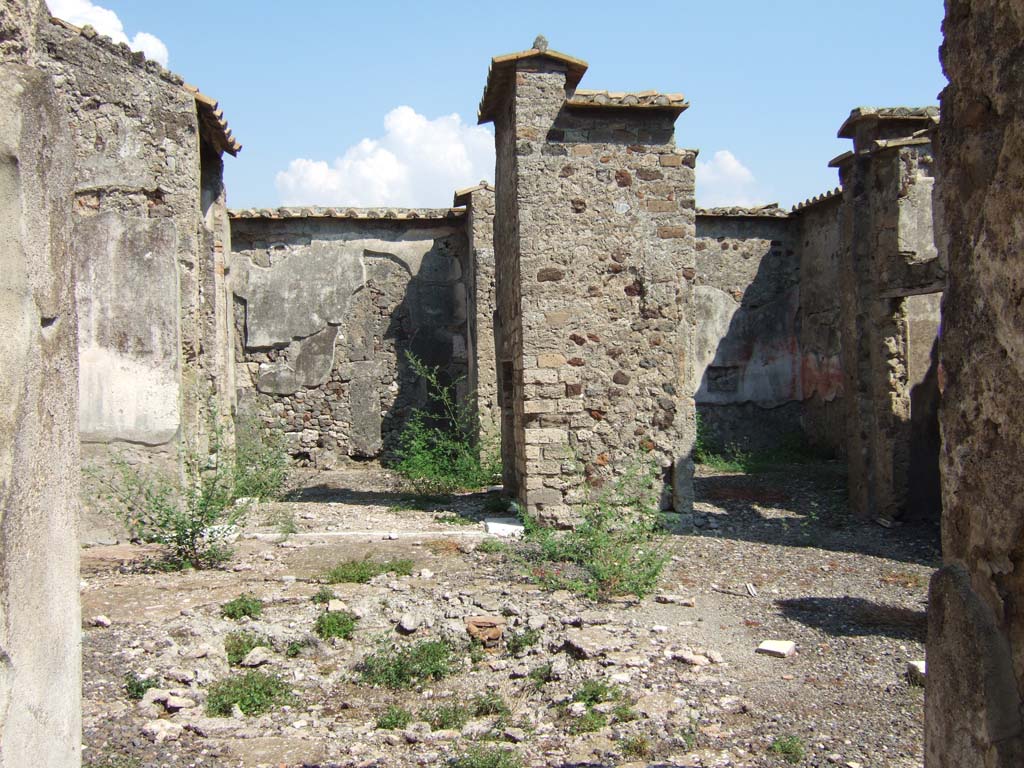 VI.2.14 Pompeii. September 2005. 
Looking east across the atrium from the entrance corridor, looking through the small tablinum towards the east wall of the garden area, on left.  
On the right is an oecus, looking through doorway towards south-east corner. The south side of the atrium was not photographed.
According to Kuivalainen, in the oecus was a painting of a figure sitting on a barrel.
He comments: Most sources do not mention this painting at all. 
Bacchus and a barrel is a rare combination, but the playful nature of the two counterparts supports the identification. Silenus is also shown riding a donkey. 
This kind of humorous iconography is more common in Bacchic sculpture.
Barrels were relatively rare in the first century AD, with increasing use in place of amphorae becoming more usual in the later second century.
The scene combines Bacchus with his characteristic product in an unusual reference.
See Kuivalainen, I., 2021. The Portrayal of Pompeian Bacchus. Commentationes Humanarum Litterarum 140. Helsinki: Finnish Society of Sciences and Letters, (p.103, B16, D14).
