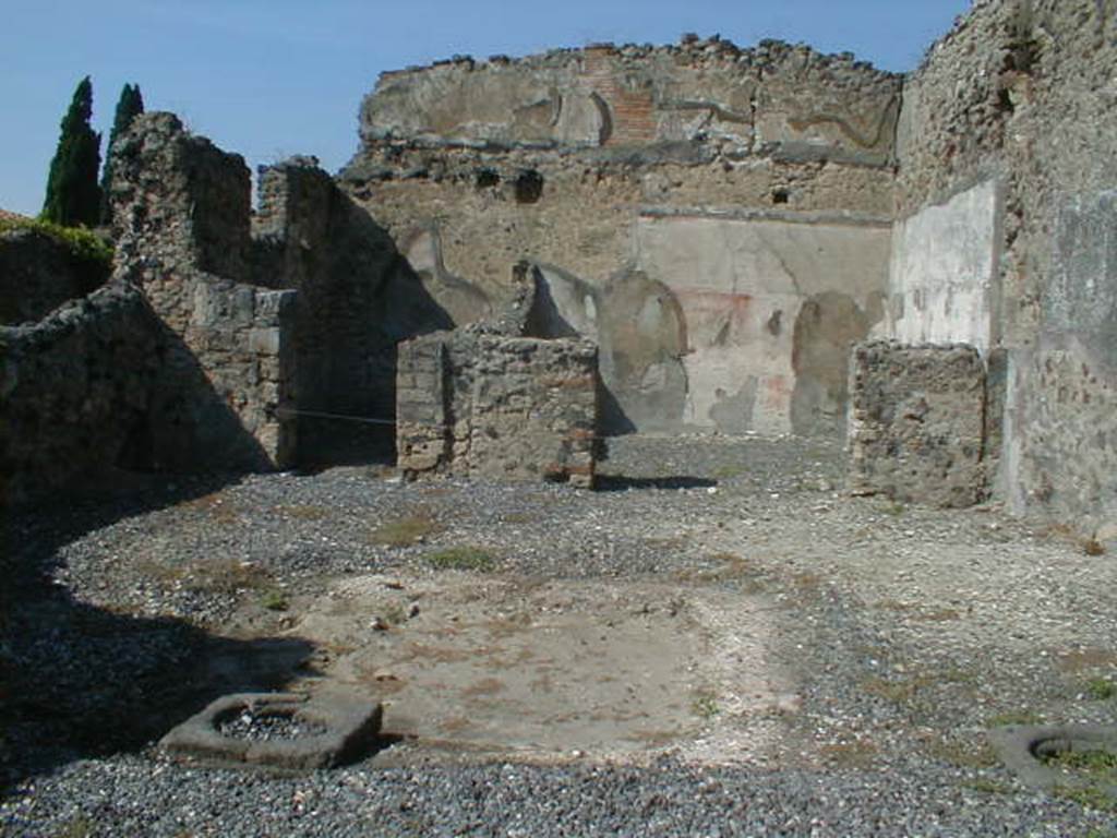 VI.5.13 Pompeii. September 2004. Looking north across atrium towards rear rooms.
According to Bonucci, 
“The room on the left would have been a bedroom; the larger one on the right was the tablinum, which was also forced to serve as the dining room, because no other triclinium was found. Found in the tablinum which was paved in mosaic, the remains of a painting representing Phryxus and Helle, above two figures, one standing the other seated, and higher still a pretty stucco moulding”. 
See Bonucci, C, 1827. Pompei descritta, p. 103.

According to Breton, “At the rear of the tablinum, paved in mosaic, was an almost erased painting which represented Phryxus and Helle”.
See Breton, Ernest. 1855. Pompeia, decrite et dessine: Seconde edition . Paris, Baudry, p. 256-7.

According to Fiorelli, found in the atrium were two paintings.
One showed Ulysses and Circe, the other Achilles being recognised by Ulysses at the court of Lycomedes.
In the tablinum, two badly damaged paintings were found. One of Phryxus and Helle, the other of Adonis wounded. 
There were also figures in the middle of the ornately painted architecture, Helbig’s numbers 979, 994, 1001. 
See Pappalardo, U., 2001. La Descrizione di Pompei per Giuseppe Fiorelli (1875). Napoli: Massa Editore. (p54)
According to Helbig, found in the atrium were Odysseus (Ulysses) and Circe (1329), Achilles at Skyros, (1299), and Seasons (979, 994 and 1001) 
In the tablinum, Phryxus 1252, and Adonis, 343, were found, and above was Hermes 360b,
See Helbig, W., 1868. Wandgemälde der vom Vesuv verschütteten Städte Campaniens. Leipzig: Breitkopf und Härtel.

According to Jashemski, Fiorelli thought that the atrium had a space in the middle for growing plants.
She said that Overbeck-Mau thought the planting beds were in the top of a low wall that enclosed the implvium.
There were two cistern mouths near the impluvium.
See Jashemski, W. F., 1993. The Gardens of Pompeii, Volume II: Appendices. New York: Caratzas. (p.126)
