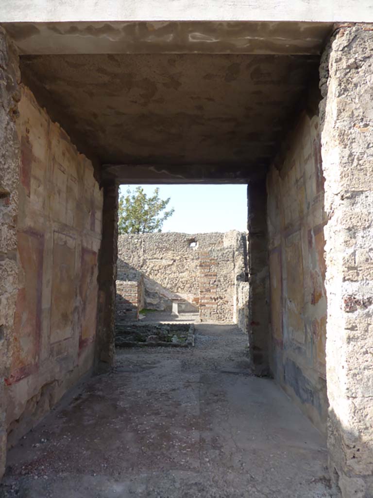 VI.7.23 Pompeii. December 2006. South wall of tablinum, looking west towards remains of fountain in courtyard.