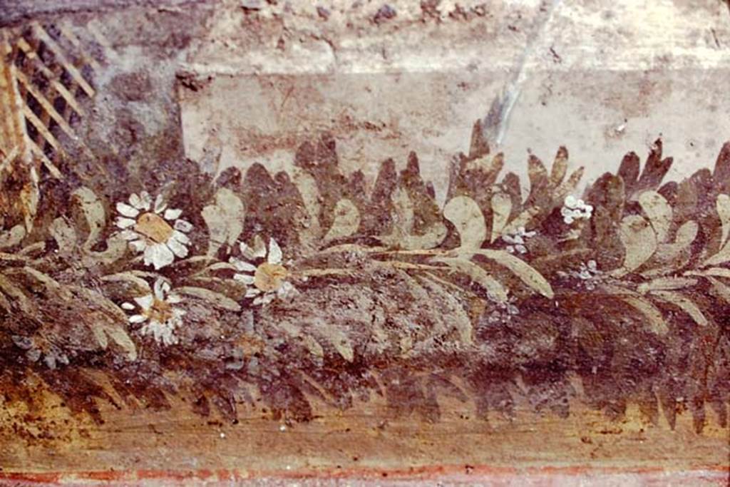 VI.7.23 Pompeii, 1978. Detail of remains of painted trellis and flower garland from south wall of courtyard, behind fountain.
Photo by Stanley A. Jashemski. 
Source: The Wilhelmina and Stanley A. Jashemski archive in the University of Maryland Library, Special Collections (See collection page) and made available under the Creative Commons Attribution-Non Commercial License v.4. See Licence and use details.
J78f0564
