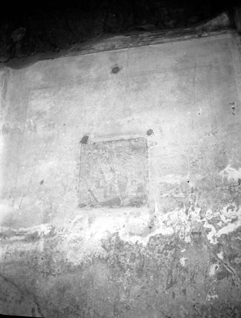 VI.9.2 Pompeii. W.578, detail from north wall of peristyle 16, the fourth picture from east end. 
According to Warscher this was a painting of Apollo.
Schefold showed it as Helbig 205.
Helbig described the painting as:
Apollo sits on a stone seat, against which his bow and quiver lean.
His right arm is propped up, his left arm lays on his thigh.
He is looking thoughtfully ahead.
In front of him a cupid is crouched, playing the god’s cithara.
See Helbig, W., 1868. Wandgemälde der vom Vesuv verschütteten Städte Campaniens. Leipzig: Breitkopf und Härtel. (205).
See Schefold, K., 1957. Die Wände Pompejis. Berlin: De Gruyter. p. 112.
Photo by Tatiana Warscher. Photo © Deutsches Archäologisches Institut, Abteilung Rom, Arkiv. 
