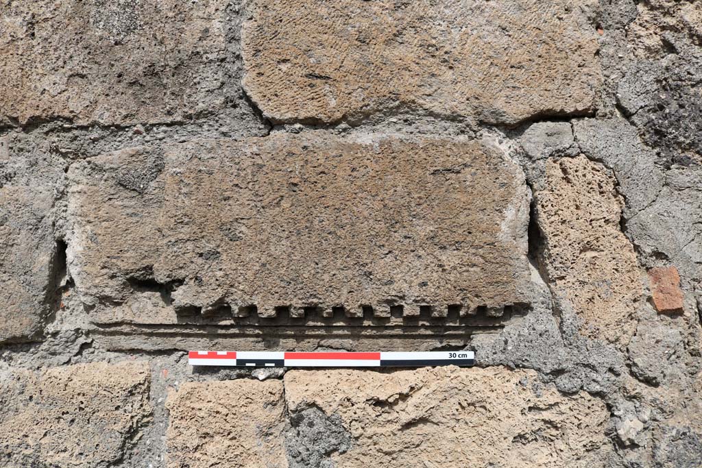 VI.10.15 Pompeii. December 2018. Detail of stone set into north wall. Photo courtesy of Aude Durand.