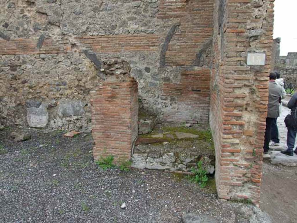 VI.10.15 Pompeii. May 2010. Masonry base for two steps to upper floor. In the east wall, the line of the wooden steps that would have continued up to the upper floor, can still be traced from the top of the second step.
