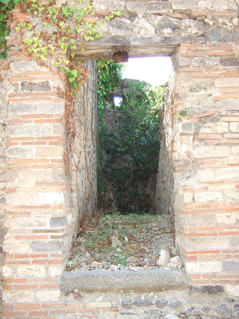 VI.11.18 Pompeii. September 2005. Back entrance doorway to yard, with steps to upper floor.  