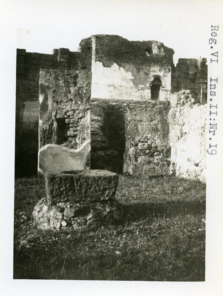 VI.1.19 Pompeii. Pre-1937-39. 
Looking north-east across atrium towards room with stairs to upper floor and doorway from VI.11.20.
Tower X can be seen in the background.
Photo courtesy of American Academy in Rome, Photographic Archive. Warsher collection no. 028.
