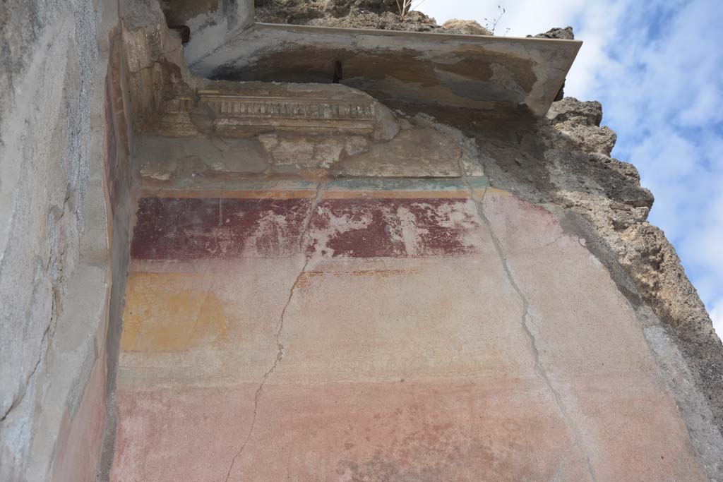 VI.14.12 Pompeii. July 2017. Detail of remaining painted stucco from west wall in south-west corner of atrium.
Foto Annette Haug, ERC Grant 681269 DÉCOR.
According to PPM –
“In the south-west corner of the atrium, the decoration remained in I Style only above the doorway to VI.14.13 in the south wall. 
On the west wall of the atrium it had been restored in III Style, with the middle zone of the wall painted red, a yellow frieze and violet with remains of a human figure.”
See Carratelli, G. P., 1990-2003. Pompei: Pitture e Mosaici. V (5). Roma: Istituto della enciclopedia italiana, (No. 5, p.250-251).

