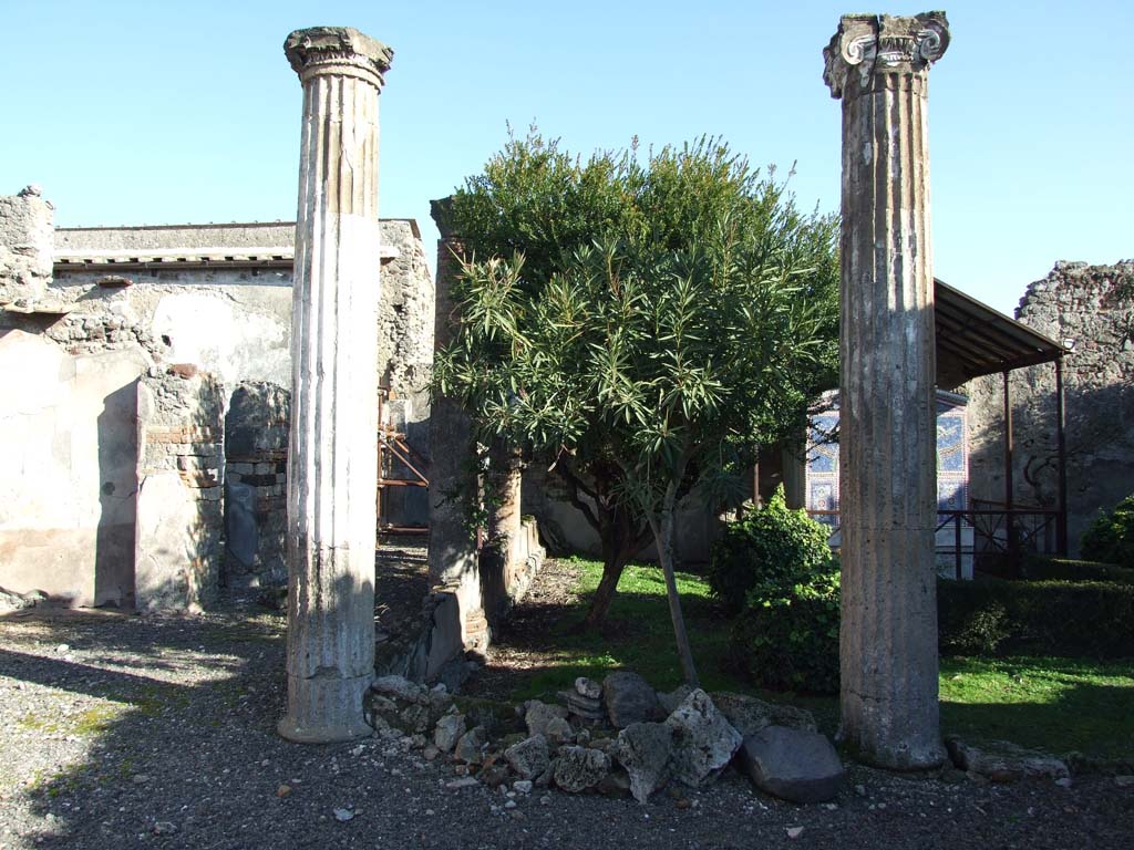VI.14.43 Pompeii.  December 2007.  North-west corner of the peristyle, with corridor to rooms at rear of the house on the north side. According to Jashemski, the portico was supported by four fluted columns joined by a low wall. See Jashemski, W. F., 1993. The Gardens of Pompeii, Volume II: Appendices. New York: Caratzas. (p.151)
