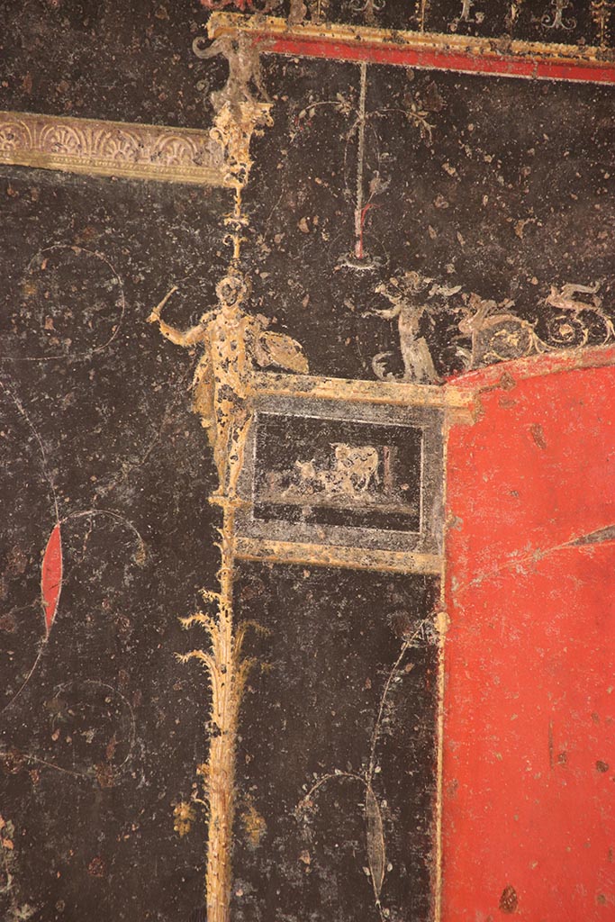 VI.15.1 Pompeii. October 2024. 
Detail from top of right side of black painted panel with candelabra from east end of north wall. 
Photo courtesy of Klaus Heese.
