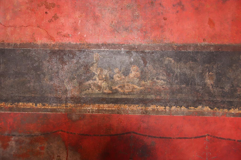 VI.15.1 Pompeii. October 2024. Detail from north wall, at east end, cupids celebrating the festival of Vesta.  Photo courtesy of Klaus Heese.