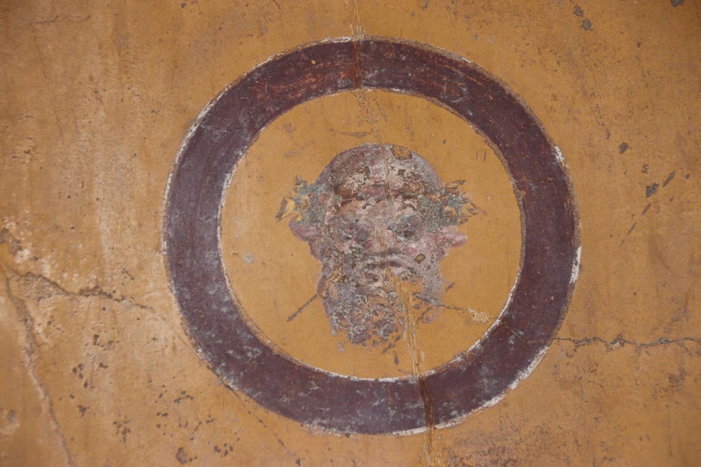 VI.15.1 Pompeii. October 2023. Painted medallion on south side of east wall. Photo courtesy of Klaus Heese.