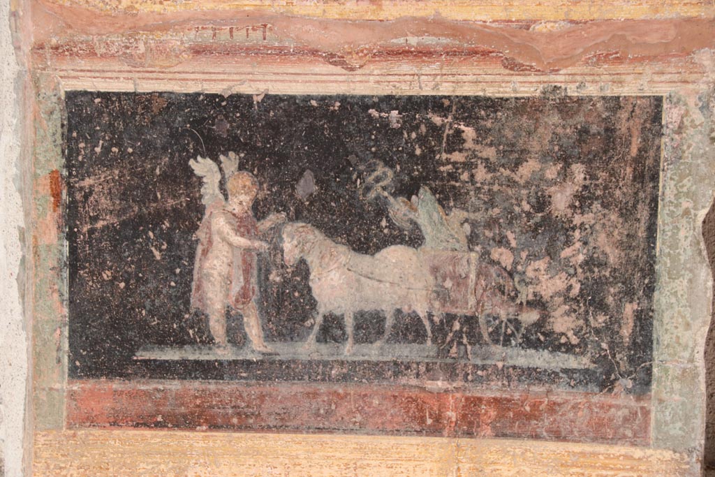 VI.15.1 Pompeii. October 2023. Painted panel on atrium wall between doorways. Photo courtesy of Klaus Heese.