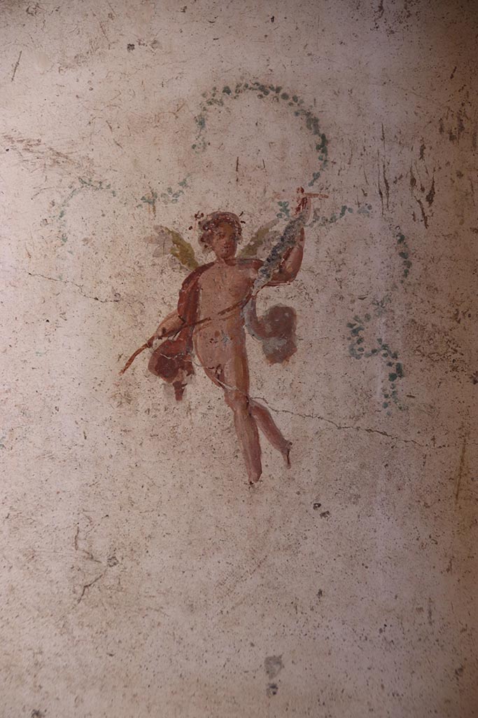 VI.15.1 Pompeii. October 2024. 
Room (f), detail of painted figure from north end of west wall. Photo courtesy of Klaus Heese.
