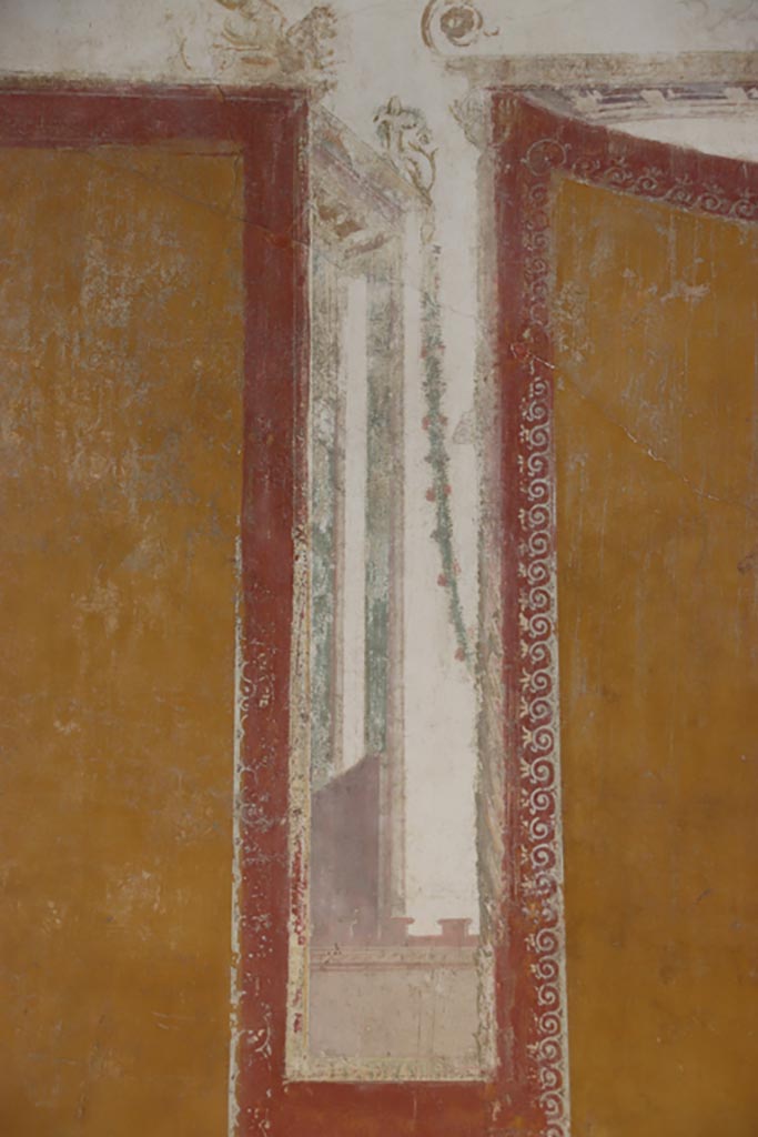 VI.15.1 Pompeii. October 2023. 
Detail of architectural painting separating panels on south wall. Photo courtesy of Klaus Heese.
