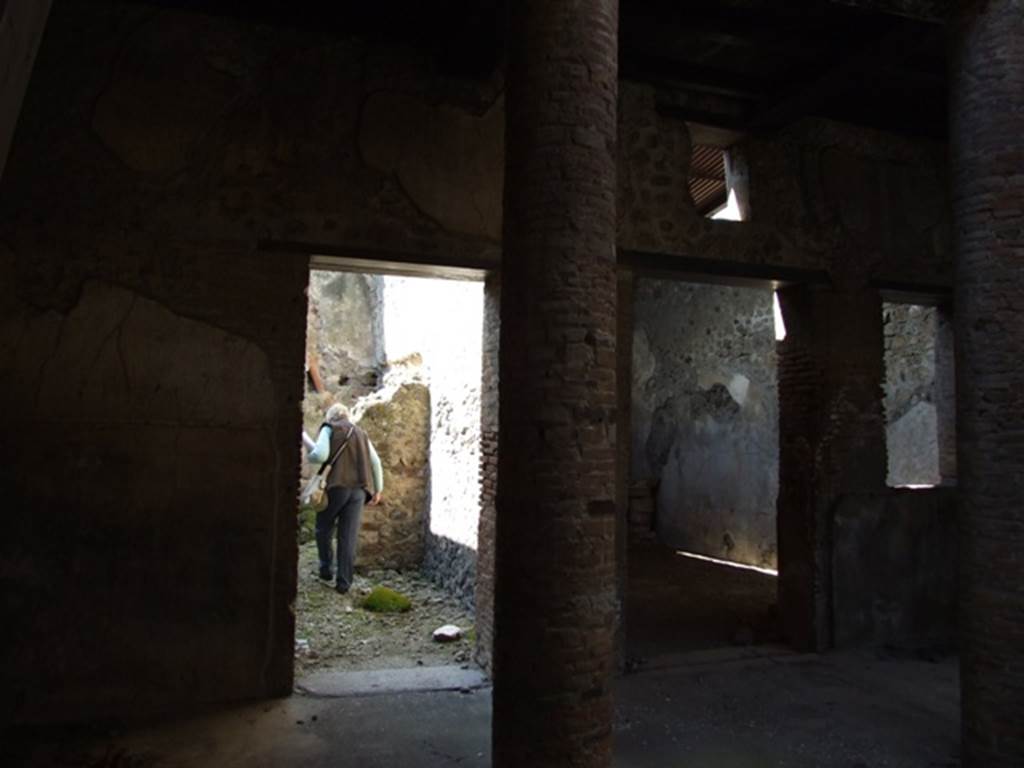 VI.15.9 Pompeii. March 2009. Looking west across atrium, to doorways of kitchen area and triclinium.