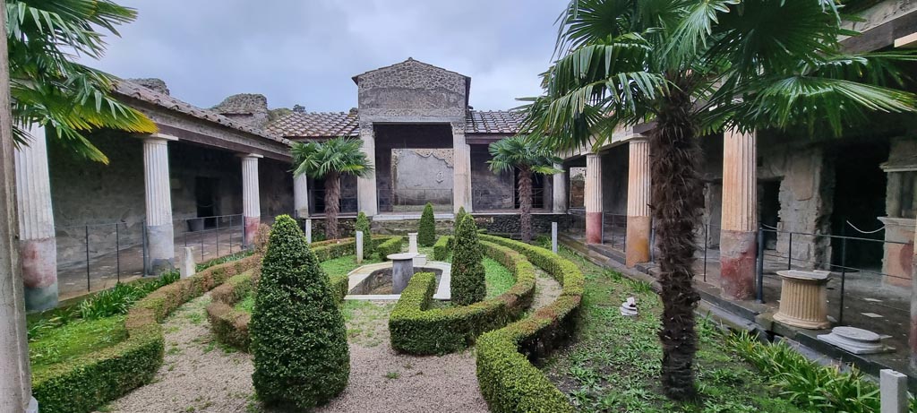 VI.16.7 Pompeii. January 2023. Room F, looking west across peristyle garden. Photo courtesy of Miriam Colomer.