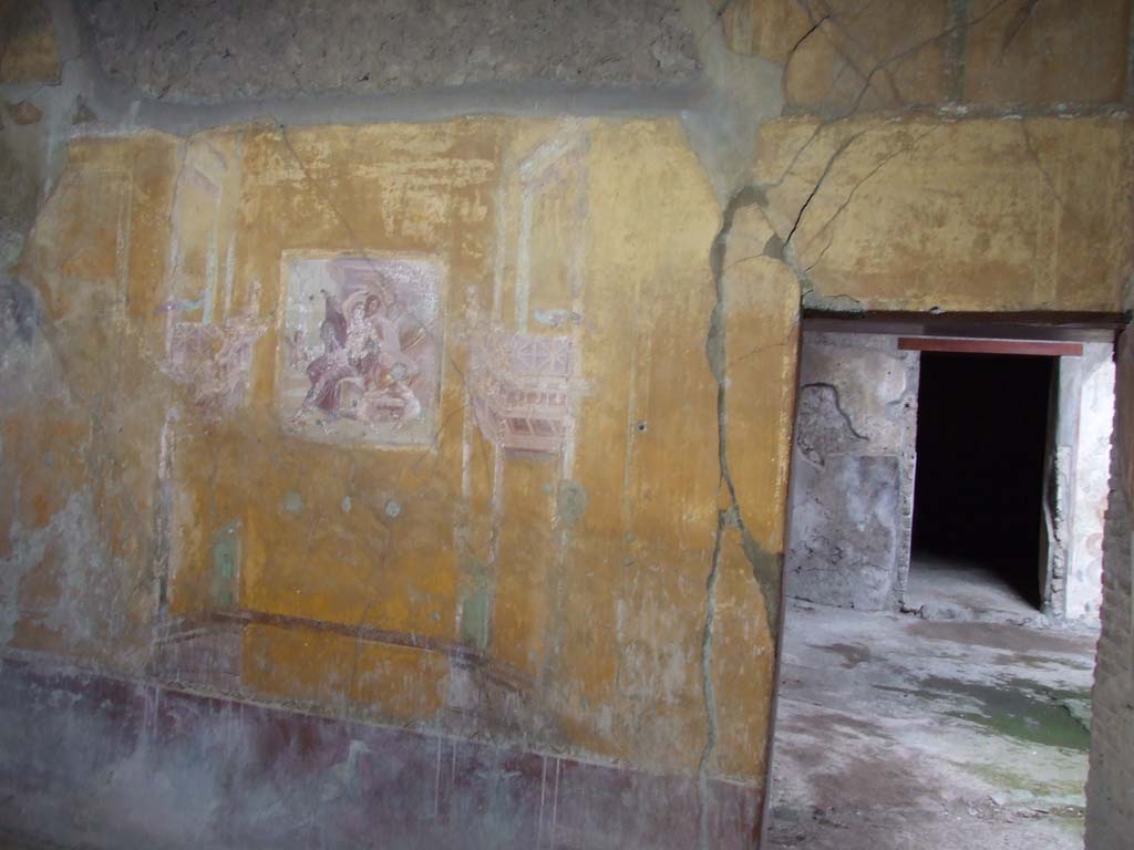 VI.16.15 Pompeii. December 2006. Looking south into doorway to room G in south-west corner of atrium. According to NdS, the triclinium, although small, was rectangular with a rough floor of cocciopesto. At the time of the disaster it was receiving a more dignified decoration. Opening in the upper part of the south wall was a window with well preserved iron grating.


