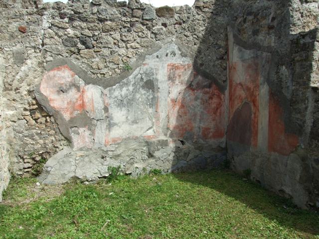 VI.16.32 Pompeii. March 2009. Room E, east wall with central panel  (height 1.10m width 0.76m) . According to NdS, the central panel showed a painting of a sacred grove with a herm of Priapus painted in red. On the right was a high pilaster, on top of which was a large rounded vase. Near the base of the pilaster was a red statue of Minerva. To the left of the painting, were two women approaching an altar placed before Priapus, and of these that to the right carried some offerings. In front of the sacred enclosure was either a river or lake, with a bridge. At the left end of the bridge were two goats drinking. There was also another woman followed by a boy and a girl. See Notizie degli Scavi di Antichità, 1908, (p296-7).
