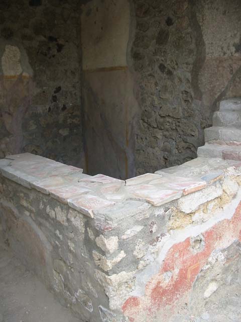 VI.16.33 Pompeii. May 2013. Shelving in south-west corner of bar, with remains of painted decoration. Photo courtesy of Paula Lock.
