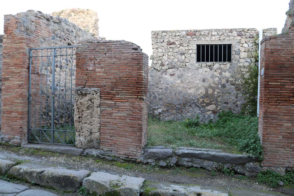 VI.16.36 Pompeii, on left. December 2018. Entrance doorways on east side of Vicolo dei Vettii. Photo courtesy of Aude Durand.