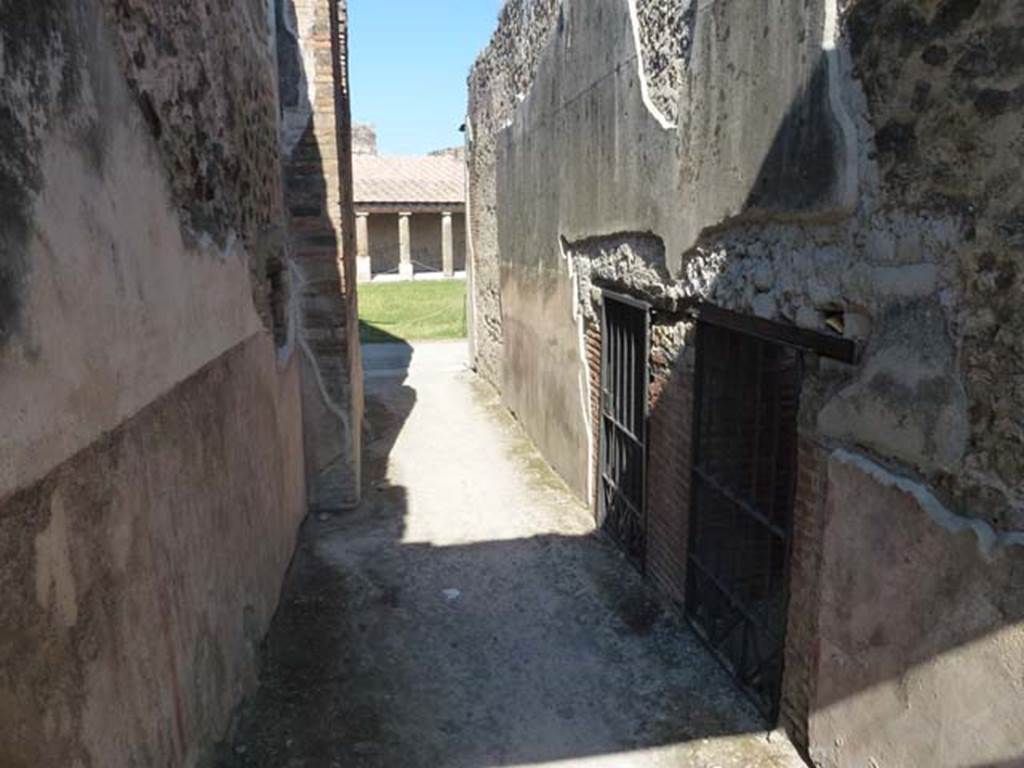 VII.1.8 Pompeii. June 2012. Corridor H, looking east from VII.1.51 to north-west corner of gymnasium C. On the right are the entrances to two long corridors. The first nearest entrance is to a corridor linking the backs of VII.1.52-58. The second farther entrance is to a corridor that runs along the back of the west wall of the baths. Photo courtesy of Michael Binns.