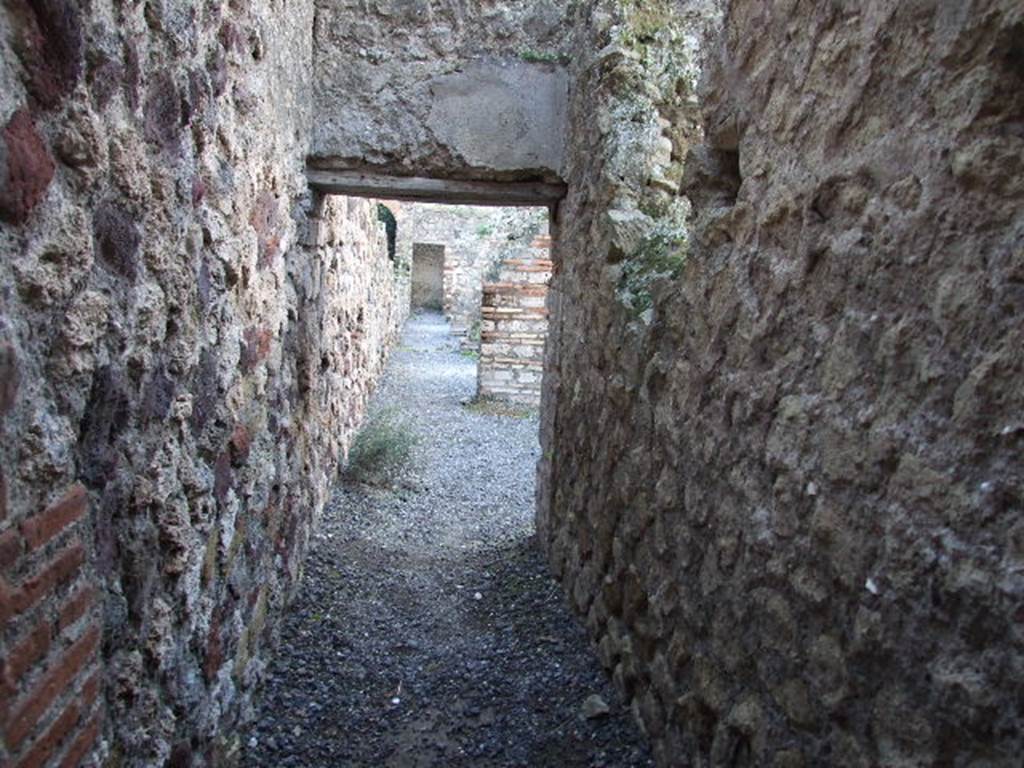 VII.1.8 Pompeii. December 2006. Corridor linking the rear of shops VII.1.52 to VII.1.58. Underneath is the start of an underground corridor running from room U.
