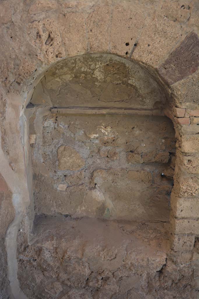 VII.1.40 Pompeii. September 2019. Detail of niche in north-east corner of atrium.
Foto Annette Haug, ERC Grant 681269 DÉCOR.
According to Boyce –
In the east wall of the atrium, near the door to a side room, there was originally a large niche (h.0.93, w.0.67, d.0.28, h. above the floor 0.55) decorated with a painted pattern of small coloured blocks in the manner of the First or Second Style – apparently the lararium.
When the atrium was redecorated in the Fourth Style, the surface of the niche was covered over without filling up the niche itself, and an aperture large enough for the insertion of the hand was left. The niche thus became a place for the storage of small articles – Fiorelli suggests, for wax tablets or rolls.
See Boyce G. K., 1937. Corpus of the Lararia of Pompeii. Rome: MAAR 14, (p.61, no.244).
See Carratelli, G. P., 1990-2003. Pompei: Pitture e Mosaici. VI. (6). Roma: Istituto della enciclopedia italiana, (p. 388, no.20).
See Giacobello, F., 2008. Larari Pompeiani: Iconografia e culto dei Lari in ambito domestico. Milano: LED Edizioni, (p.244, no.A24)
.
