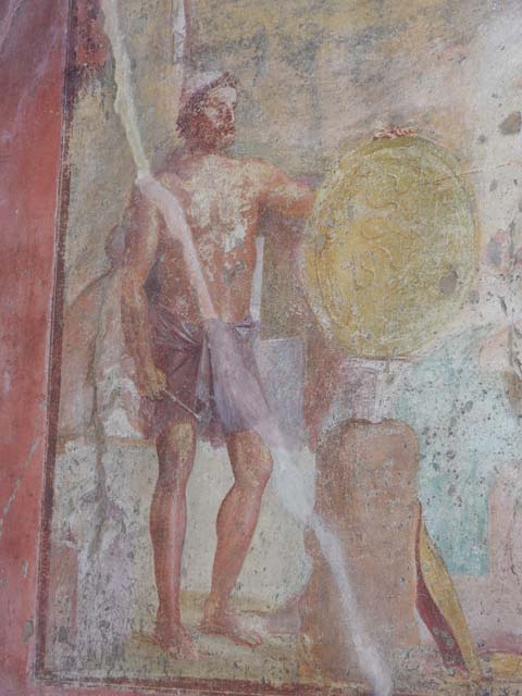 VII.1.47 Pompeii. May 2017. Exedra 10, east wall.
Wall painting of Thetis at the forge of Hephaestus receiving the shield for Achilles. 
Behind Thetis is another figure (Fate or Destiny?). 
Photo courtesy of Buzz Ferebee. 
See Carratelli, G. P., 1990-2003. Pompei: Pitture e Mosaici: Vol. VI.  Roma: Istituto della enciclopedia italiana, p. 279. 
