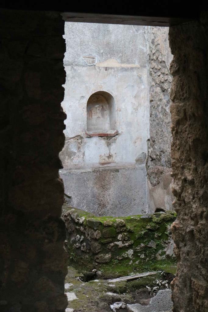 VII.1.47, Pompeii. December 2018. 
Room 17, looking west through doorway towards lararium in VII.1.46. Photo courtesy of Aude Durand.

