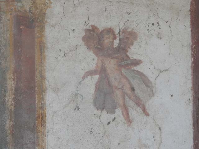 VII.4.48 Pompeii. December 2007. Room 14, cubiculum. West wall.   
Wall painting of a winged cupid.
