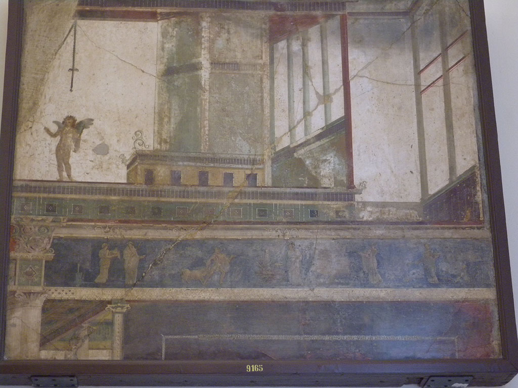 VII.6.28 Pompeii. Found on 10th April 1762. Architectural painting representing 5 doors, columns, capitals, bands and cornices of architecture; above a band is a naked cupid with a stick in the left and an object in the right; bottom scenes of sacrifice.
Now in Naples Archaeological Museum. Inventory number 9165.
See Antichità di Ercolano: Tomo Quarto: Le Pitture 4, 1765, 45-46, 221-227.
See Helbig, W., 1868. Wandgemälde der vom Vesuv verschütteten Städte Campaniens. Leipzig: Breitkopf und Härtel, (569).
