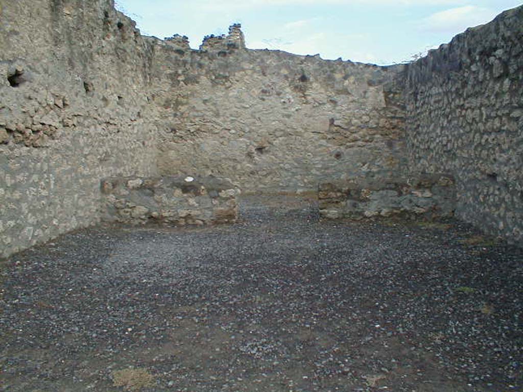 VII.7.1 Pompeii. September 2004. Looking north across shop to doorway to rear room.